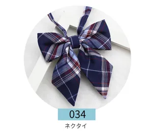 Detail shot of the navy blue plaid JK uniform bow tie, showing fabric texture and sharp corners.