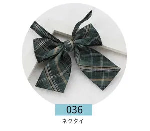 Detailed view of the dark green plaid JK school uniform bow tie, flat square design.
