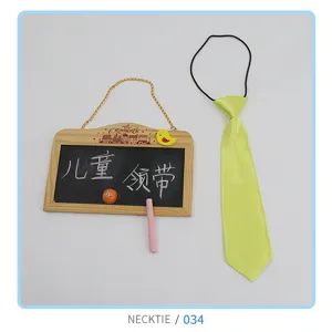 Children's yellow tie detail view, cute shiny polyester necktie with elastic band for kids.