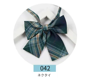 Detailed view of green plaid JK uniform bow tie, featuring classic striped fabric and ribbon.