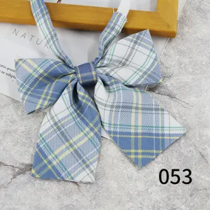 Close-up detail of the blue and white plaid JK bow tie, showing fabric texture and neat stitching.