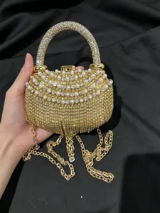 Detailansicht der goldenen Strass Abendtasche mit funkelnden Perlen und feiner Kette.