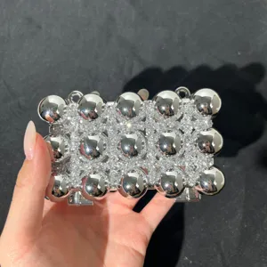 Sparkling silver rhinestone studded metal ball evening clutch bag detail view showcasing unique texture.