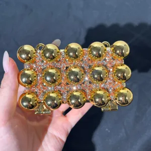 Gold rhinestone evening clutch bag detail, luxury metallic ball shoulder handbag for women