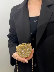 Nahaufnahme der glitzernden Strass-Herz-Abendtasche mit goldener Kette für festliche Anlässe.