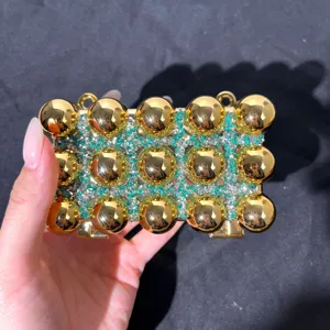 Golden sphere rhinestone evening clutch bag detail, sparkling green crystals acrylic purse.