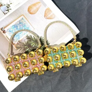 Stunning acrylic evening clutch bag with rhinestone handles and gold sphere details for women.