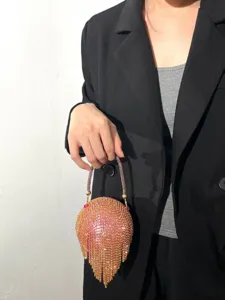 Gros-plan sur le sac de soirée à franges et strass brillants avec poignée perlée, élégant.
