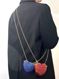 Nahaufnahme einer glitzernden Strass-Herz-Mini-Umhängetasche mit goldener Kette.