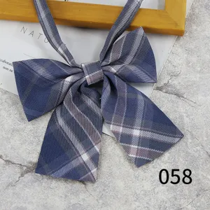 Close-up detail shot of a Japanese style blue plaid JK collar bow tie with ribbon straps.