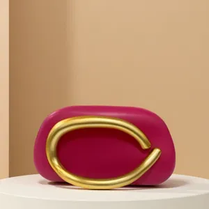 Magenta mini evening bag detail, retro gold metal circular handle, stylish luxury handbag.
