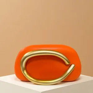Mini orange shoulder crossbody bag with retro chunky gold metal handle for evening party wear.