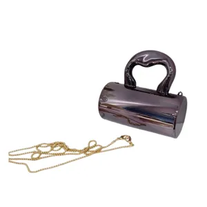 Schicke metallische Acryl Zylinder Abendtasche mit skulpturalem Griff und Goldkette.