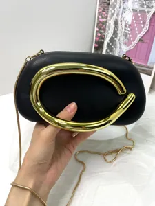 Classic black leather evening clutch bag featuring luxury metal handle and gold chain strap.