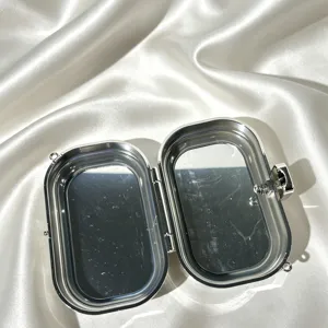 Silver metal evening clutch bag open interior detail, stylish metallic hard case for women.