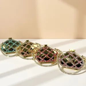 Detailed close-up of four colorful crystal rhinestone acrylic evening clutch bags with metal trim.