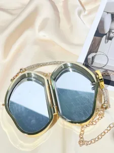 Golden rhinestone mini acrylic box clutch bag detail view with interior mirrors and chain strap.