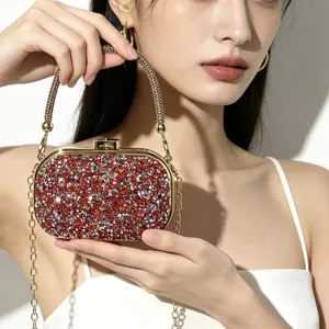 Stunning red and silver glitter clutch detail, elegant gold chain strap and metal frame.