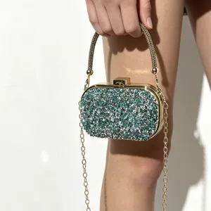 Elegant sparkly evening clutch bag with chain strap and rhinestone embellishment for women.