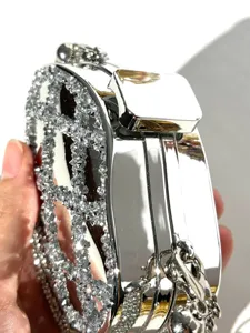 Silver rhinestone minaudiere evening clutch bag with sparkling crystals and metal lock.