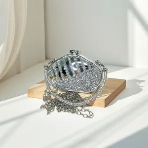 Close up detail view of sparkling crystal rhinestone mini box clutch bag with chain.
