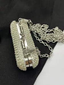 Detailed view of silver rhinestone mini box clutch evening bag with metal chain strap.