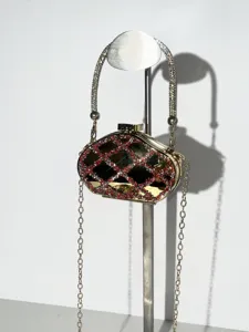 Detail shot of mini rhinestone evening clutch bag with crystal handle and chain strap.