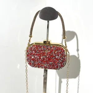 Sparkling rhinestone evening clutch bag detail showcasing dazzling red and silver crystal stones.