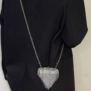 Mini rhinestone heart crossbody bag with silver chain strap, perfect for evening parties and club wear.