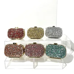 Close-up view of shimmering glitter evening clutches with metallic frames and secure clasps.