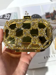 Luxury crystal evening clutch bag, gold acrylic minaudiere purse with sparkly rhinestones.