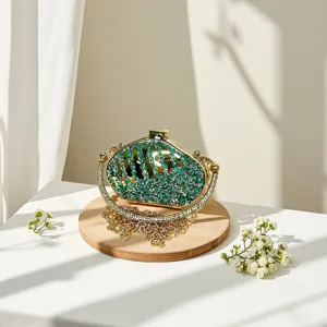 Detailed shot of sparkling rhinestone evening clutch, luxury green crystal mini chain handbag.
