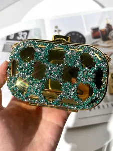 Luxurious crystal evening clutch bag with green and silver rhinestones on metallic gold frame.