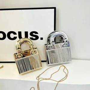 Mini metallic rhinestone evening handbag with rigid handles and chic party style design.