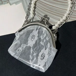 Close-up detail of white lace kiss-lock coin purse with elegant pearl chain strap.