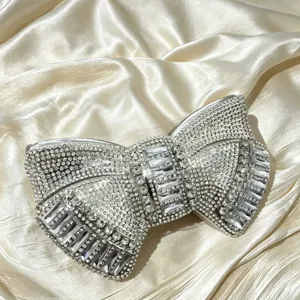 Exquisite crystal bow evening clutch bag with full rhinestones, luxury style for parties.