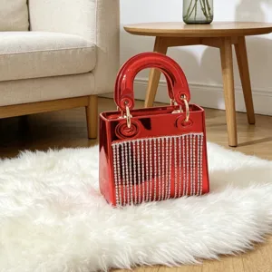 Red glossy acrylic evening handbag with rhinestone fringe, elegant top handle mini party bag.