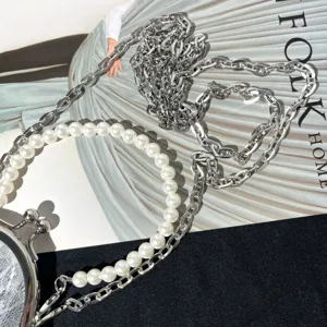 Retro metal kiss-lock coin purse frame with elegant pearl handle and stylish silver chain strap.