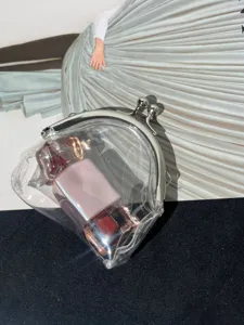 Transparent PVC kiss lock coin purse detail view, stylish clear handbag showing interior.