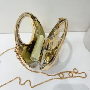 Gold mini evening clutch bag with metal chain strap and clear acrylic detail display.