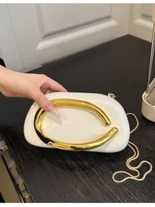 Elegant white evening clutch bag with bold curved gold metal handle and stylish chain strap.