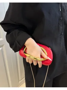 Elegant red evening clutch bag with chunky gold metal ring handle and chain strap for women