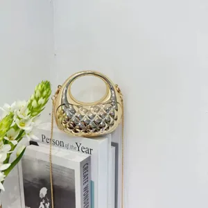 Close-up of the stylish metallic gold mini handbag with circular handle and chain strap.