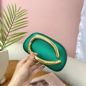 Green acrylic evening bag with a stylish gold handle, perfect for vintage retro party wear.