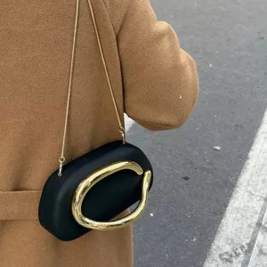 Detail shot of the retro mini evening crossbody bag featuring a chic gold metal handle.