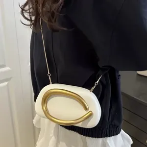 Stylish white evening clutch bag featuring bold gold metallic C-shape handle and fine chain strap