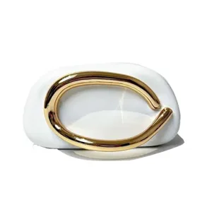 Elegant mini evening shoulder bag with unique golden curved handle and white minimalist design.