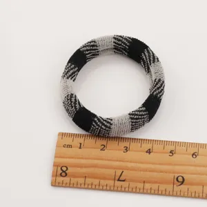 Black and white plaid elastic hair tie, soft towel ring hair accessory product detail view.
