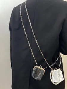 Retro Chinese style mini kiss-lock coin purse detail shot, featuring metal chain strap and dual bags.
