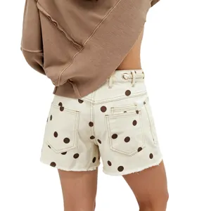 Women denim shorts with brown polka dots, eyelet waist and raw hem detail. Back view.